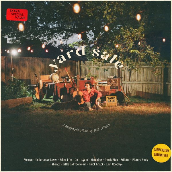 Yard Sale cover: Seth Celdrán on the grass of a back yard at dusk, among his guitars, amps and tape machines, under string lights